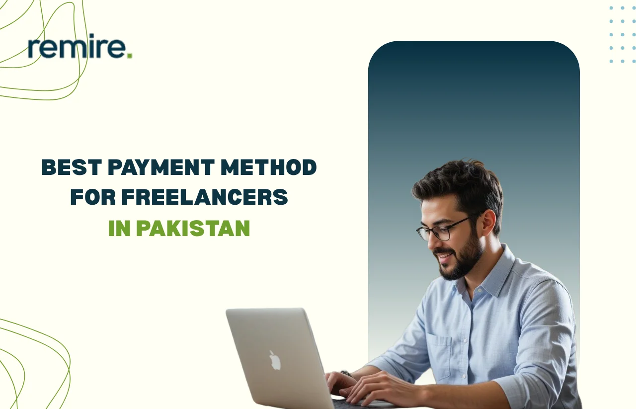 A freelancer in a checkered shirt working on a laptop while holding a payment card, illustrating Remire's guide to the Best Payment Method for Freelancers in Pakistan.