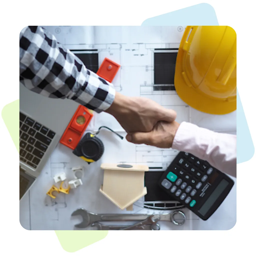 Two professionals shaking hands over a workspace with a yellow hard hat, calculator, and house model, illustrating Contractor Management Solutions for Every Business from Remire.